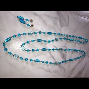 Long blue necklace with earrings in combination.